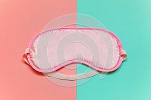 Sleeping mask on pink and blue background