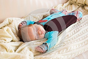 Sleeping newborn baby on a blanket