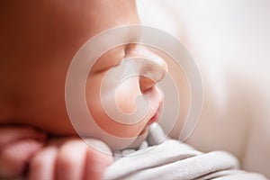 Sleeping newborn baby boy close-up portrait. Baby wrap