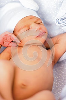 Sleeping newborn baby boy with funny hat. Babyface close-up. Relaxing infant photo