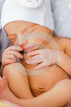 Sleeping newborn baby boy with funny hat. Babyface close-up. Very sweet infant