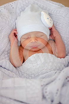 Sleeping newborn baby boy with funny hat. Babyface close-up. Very sweet infant