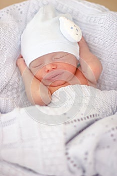 Sleeping newborn baby boy with funny hat. Babyface close-up. Very sweet infant