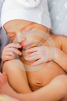 Sleeping newborn baby boy with funny hat. Babyface close-up. Very sweet infant photo