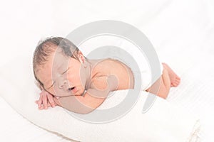 Sleeping newborn baby in bright wrap, 2 weeks baby