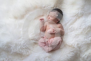 Sleeping Newborn Baby Girl with Heart Shaped Pillow