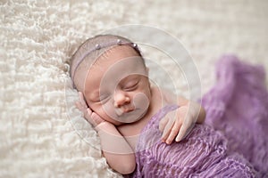 Sleeping Newborn Baby Girl with Lavender Blanket