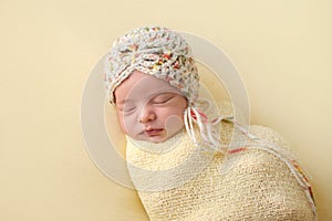 Sleeping Newborn Baby Girl Swaddled in Yellow