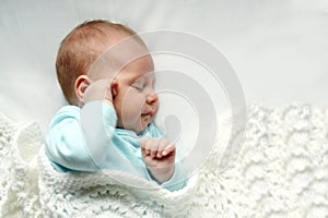 Sleeping Newborn Baby Girl in WHite Blankets