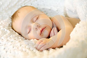 Sleeping Newborn Baby Girl in WHite Blankets