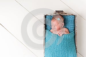 Sleeping Newborn Baby Girl in Wood Crate