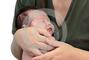 Sleeping newborn baby in the hands of her mother
