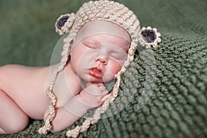 Sleeping newborn baby in a knitted blanket