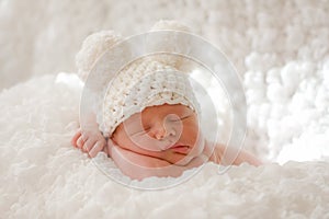 Sleeping newborn baby in knitted cap photo