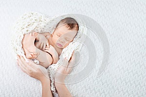 Sleeping newborn baby  in mother hands - hearth shape