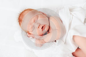 Sleeping newborn baby in a wrap