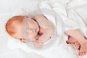 Sleeping newborn baby in a wrap