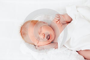 Sleeping newborn baby in a wrap