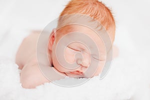 Sleeping newborn baby in a wrap