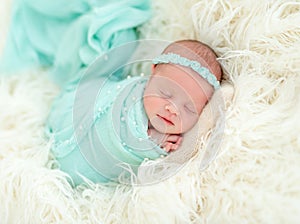 Sleeping newborn in blue headband