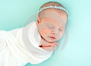 Sleeping newborn in blue headband