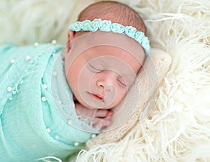 Sleeping newborn in blue headband