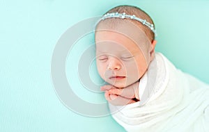 Sleeping newborn in blue headband