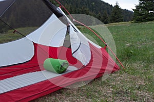Sleeping pad in open green 2-wall tent in the morning in mountain pass in Mala Fatra mountains, Slovakia