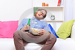 Sleeping at a party with popcorn and beer