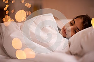 Sleeping, peace and girl child relax in a bed with comfort, dreaming or resting at home. Sleep, dream or calm female kid
