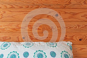 Sleeping pillow against wooden cottage interior wall