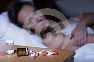 Sleeping pills on bedside table