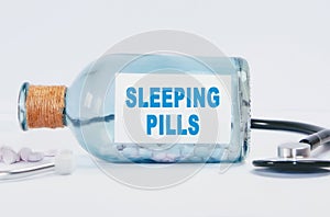 Sleeping pills inscription on a glass bottleneck. Medicine concept