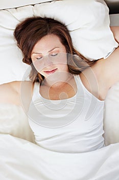 Sleeping, rest and woman in bed from above, peaceful and enjoying a calm nap in her home. Top view, dreaming and female