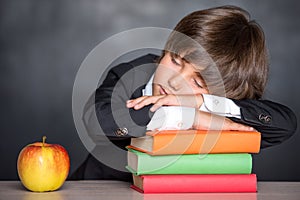 Sleeping school boy in classroom