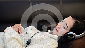 Sleeping shot of Asian woman teenager listing love music