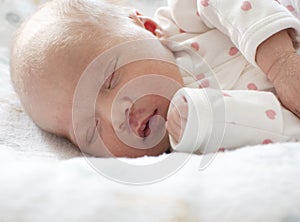 Sleeping white caucasian newborn baby closeup. Angel's kiss, stork bite birthmark