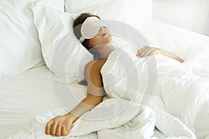 Sleeping woman wearing eye mask in the bedroom