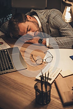 sleeping young businessman in office