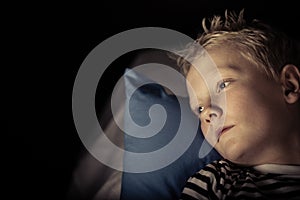 Sleepless little boy laying on pillow