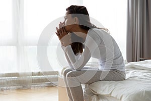 Depressed woman got up sit on bed and thinking photo