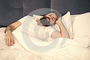 Sleepless night. Sleep disorders concept. Man bearded hipster having problems with sleep. Guy lying in bed try to relax