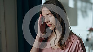 Sleepless woman looking window holding glass closeup. Upset girl with headache