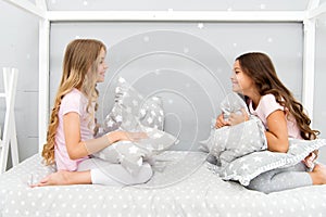 Sleepover party ideas. Girls happy best friends or siblings in cute stylish pajamas with pillows sleepover party