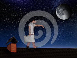 Sleepwalker wearing pajamas with pillow on roof in night photo