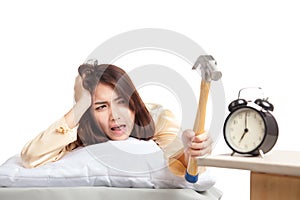 Sleepy Asian girl wake up hit alarm clock with hammer