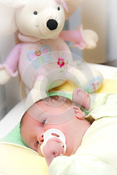 Sleepy baby girl in crib