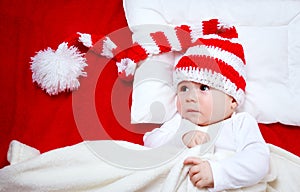 Sleepy baby on red blanket