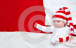 Sleepy baby on red blanket