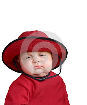 Sleepy baby in red hat.